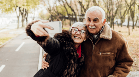 Older man taking a selfie with daughter. Lasting power of attorney.